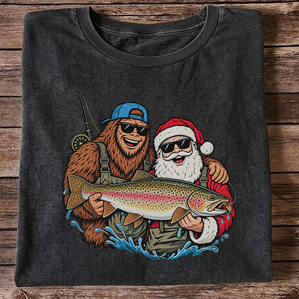 Bigfoot and Santa Holding Rainbow Trout Christmas Fishing Graphic T-Shirt