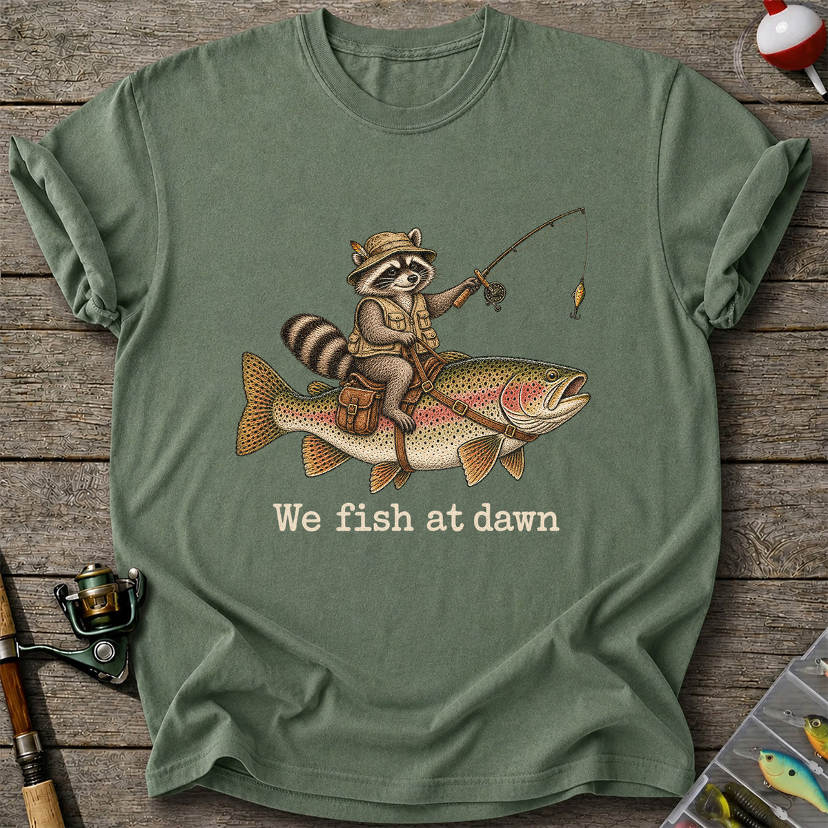 We Fish at Dawn Raccoon Riding a Rainbow Trout Fishing T-Shirt