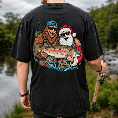 Bigfoot and Santa Holding Rainbow Trout Christmas Fishing Graphic T-Shirt | Back Print