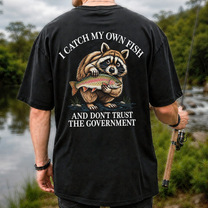 Raccoon Holding Rainbow Trout Fishing Graphic T-Shirt | Back Print