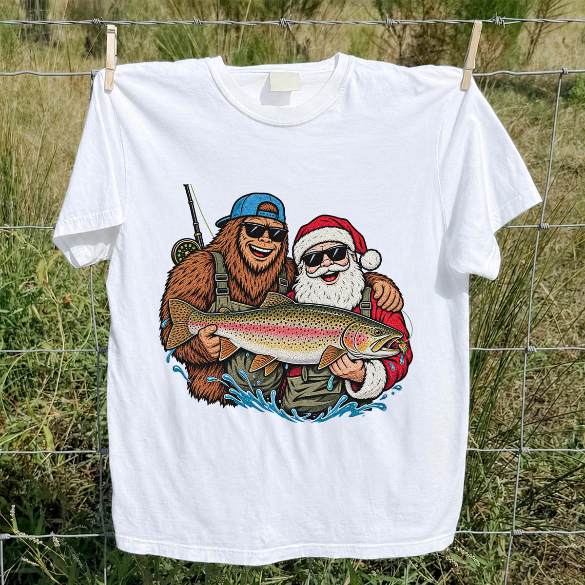 Bigfoot and Santa Holding Rainbow Trout Christmas Fishing Graphic T-Shirt