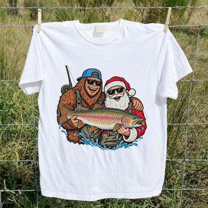 Bigfoot and Santa Holding Rainbow Trout Christmas Fishing Graphic T-Shirt