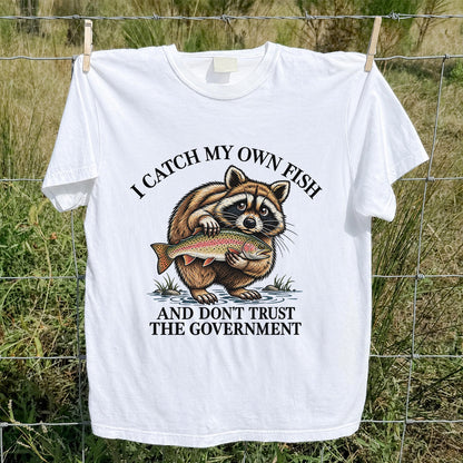 Raccoon Holding Rainbow Trout Fishing Graphic T-Shirt